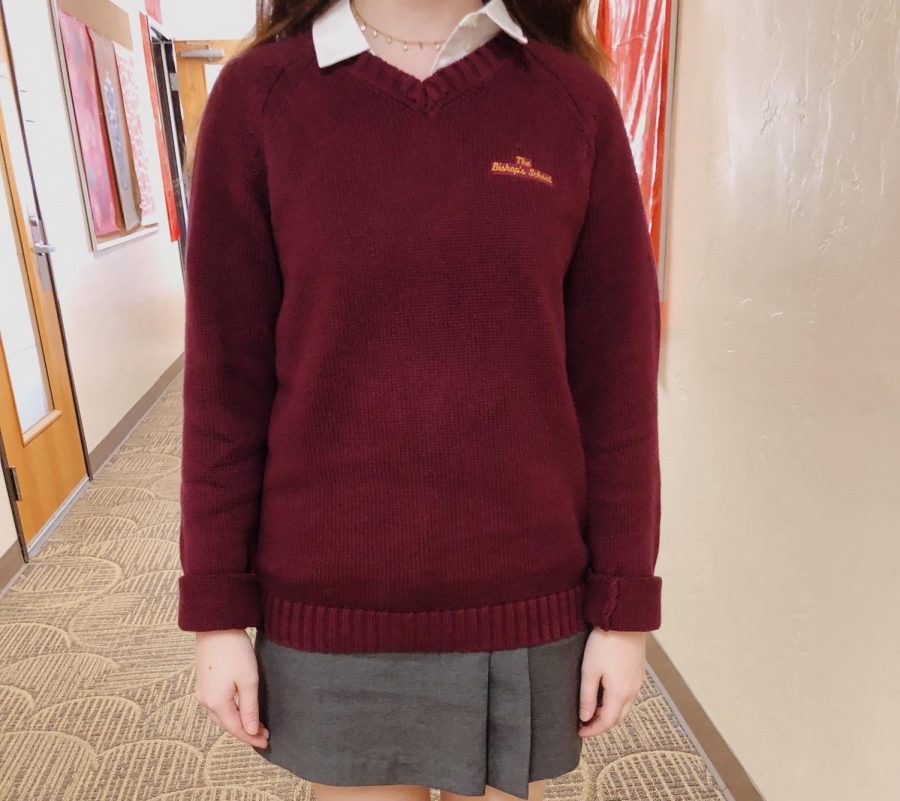 A student wears a maroon sweater on dress day. 