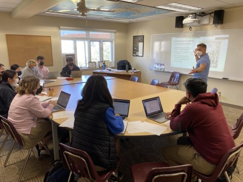 Teachers such as History and Social Sciences Teacher Mr. Damon Halback are on-campus in KN-95 or N-95 masks, utilizing the school’s new view-only Zoom policy to help students learning from home.