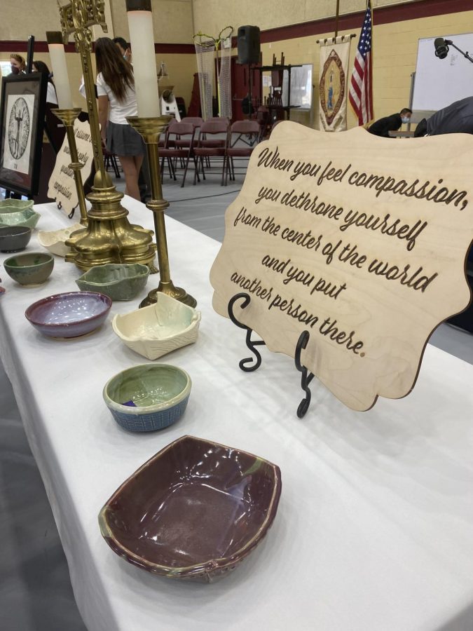 Student-created+ceramic+bowls+stood+on+the+altar+to+the+right+of+the+podium.+Part+of+the+Empty+Bowls+Project%2C+they+would+be+auctioned+off+at+the+2022+Bishop%E2%80%99s+Auction+to+raise+money+to+solve+the+issue+of+food+insecurity.+
