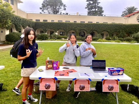 South Asian and Pacific Islanders (SAPI) leaders Nirvana Shiwmangal (‘25) and Safina Abraham (‘25) and member Gabby Gaspar (‘25) share their culture’s snacks at their booth during the club fair on September 29th. 
