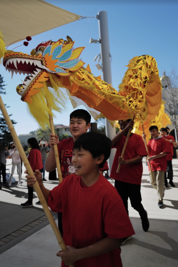 Some+students+participated+in+the+dragon+dance+during+both+middle+and+upper+school+lunch.+Holding+long%2C+wooden+poles+on+various+parts+of+the+dragon%E2%80%99s+body%2C+the+students+could+make+the+dragon+look+like+it+was+dancing+by+swaying+in+different+directions.