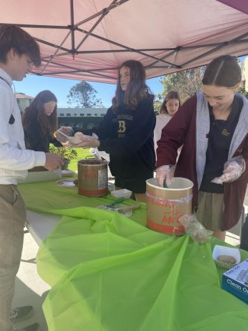 Lucky Ducklings members sophomores Gabby Anderson and Adelaide Kessler sell cookies and ice cream scoops to students at the club’s bake sale on January 31 during Lucky Duckling’s week.
