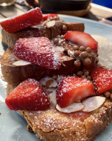 The Nutella Nuts French Toast from Sugar and Scribe paired with sliced strawberries and a light vanilla bean whipped cream is a delicious sweet brunch option.