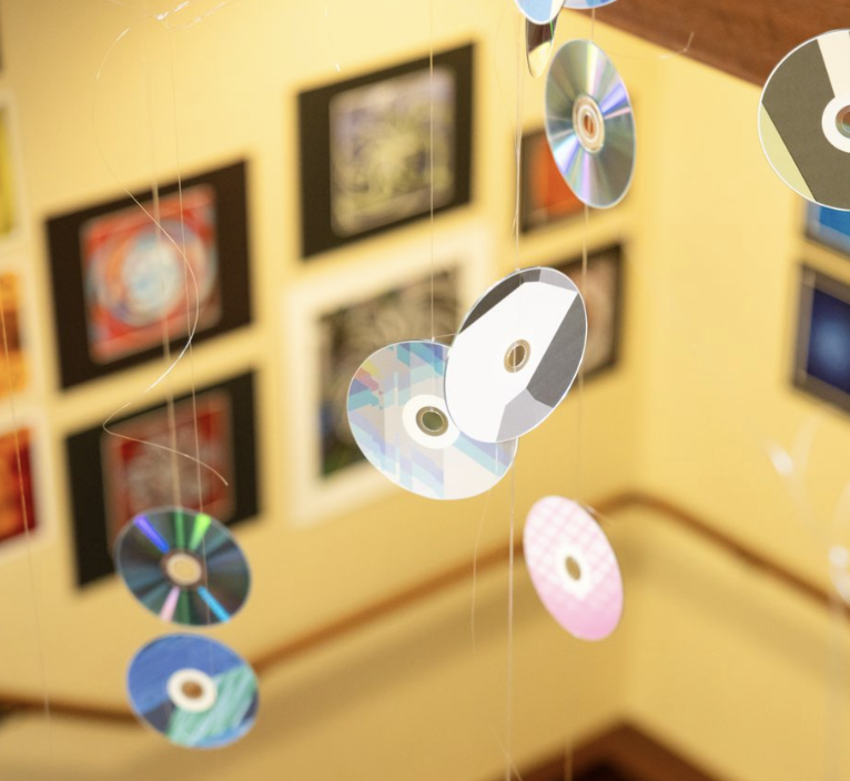 Wyatt Wainio’s 100+ piece art exhibition was displayed in the library from October 18th to December 1st. Alongside the creative, abstract digital pieces, a memorable part of the exhibition were the array of CDs hung from above.
