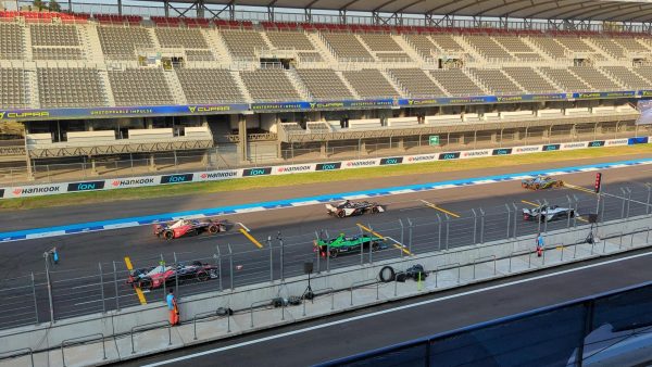 The sun rising and shining on the Formula E race cars lined up for the 2023 Mexico City ePrix qualifiers. 