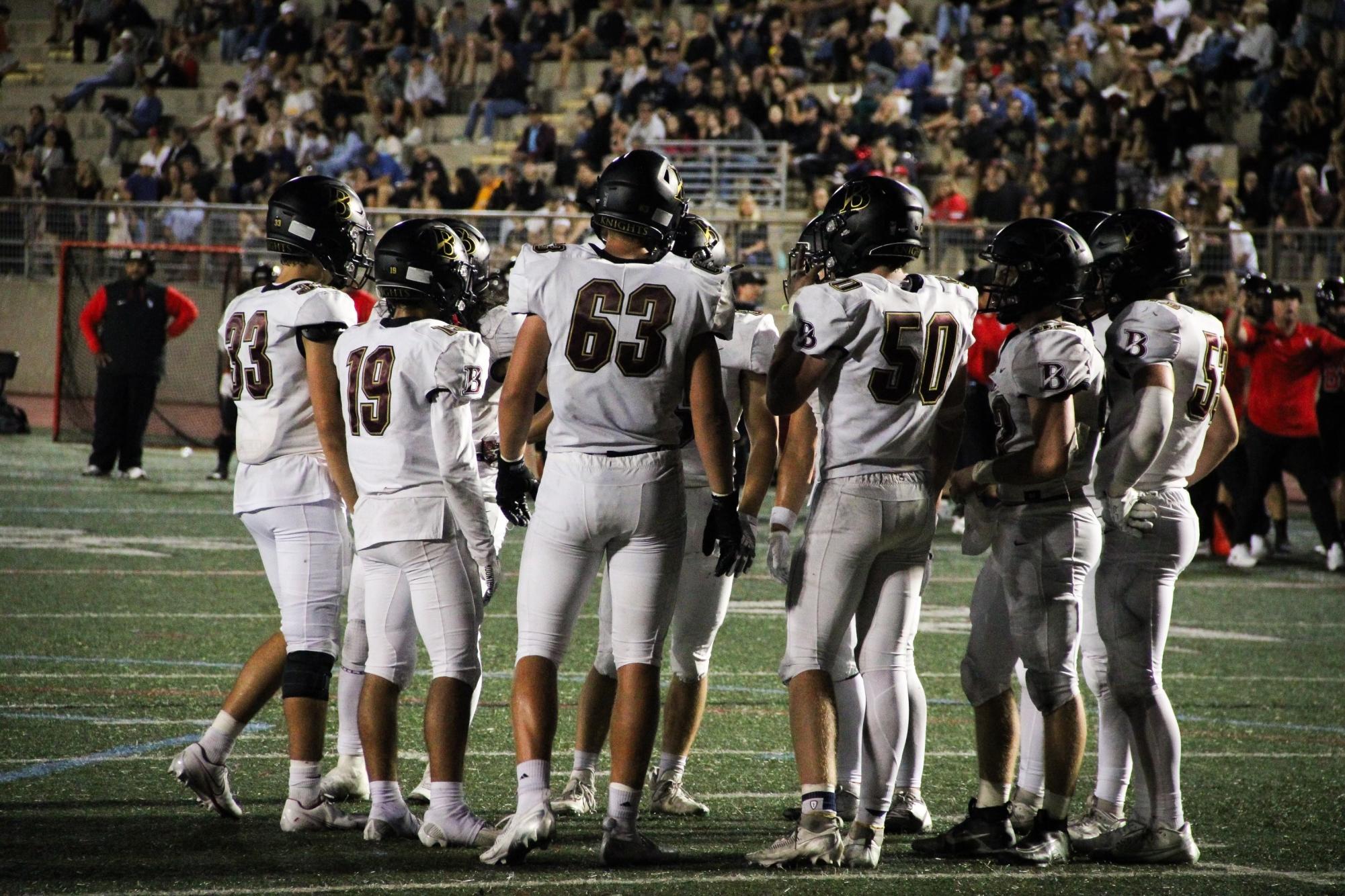 The Boys’ Varsity Football Team huddled up to discuss their next play.
