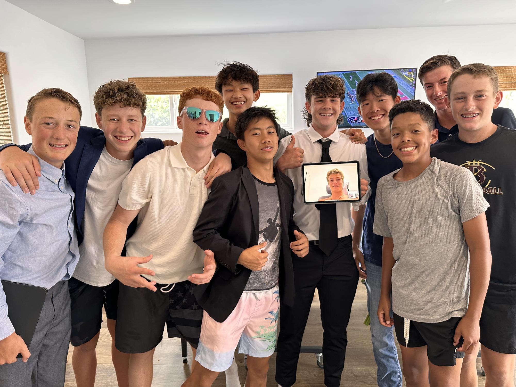 Ninth graders (left to right) Jack Cassidy, Sam Harvey, Enzo Liotta, Max Nguyen, Chace Sun, Beckett Nielsen, Jonah Hong, Will Kelly, JT Cochrane, Reid Dielman, Theo Lightner (on the iPad), and Ryder Sherman (not shown), in a Fantasy Football league gathered at Max’s house to draft players together at the start of the season.