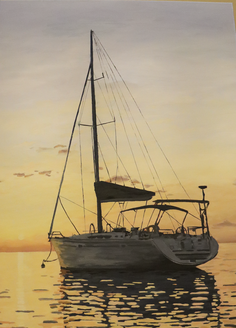 Sunset at Sea: A sailboat floats on the glistening waters in Italy.
