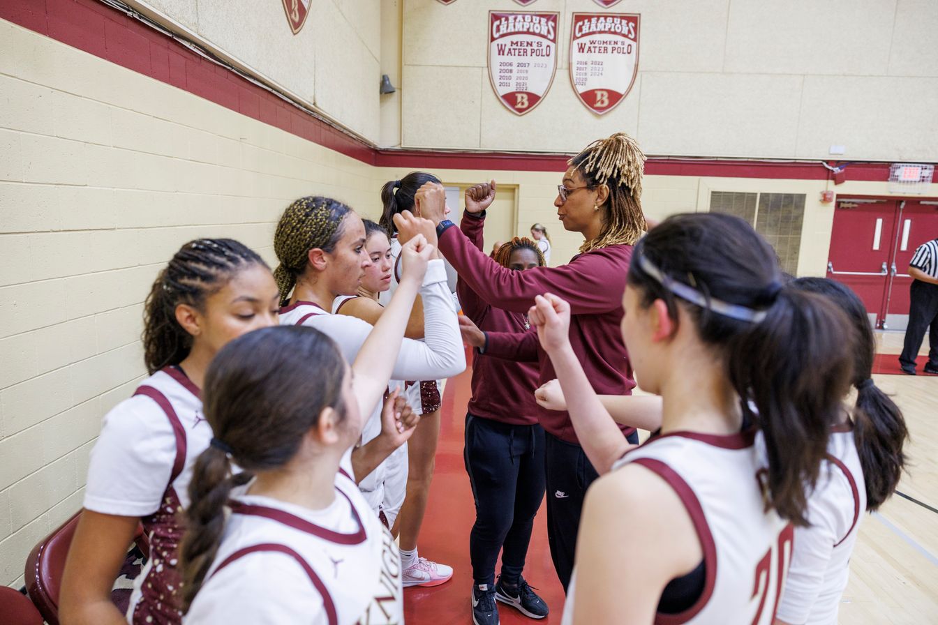 Huddled together between intense quarters at their home game on December 6 against Our Lady of Peace Academy, the girls cheer together with a proud “Knights!”