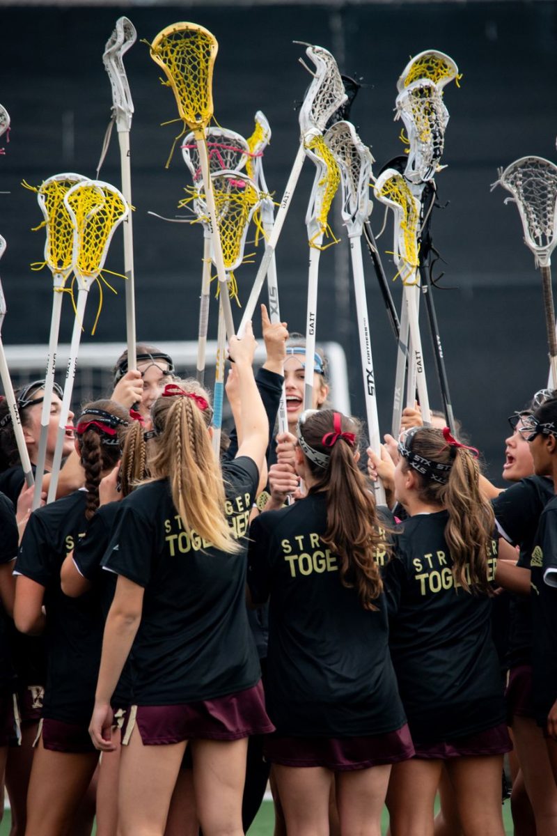 The Girls’ Lacrosse Team captains (Natalie Marvin (‘25), Alex Pfister (‘25), Laine Jeffery (‘25), and Kendall Kearney (‘25)) lead the cheer before their victory against Canyon Crest Academy.
