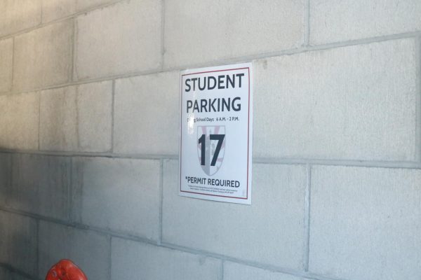The back row of parking spots in the garage is dedicated to students. Each spot has a sign with a number that corresponds to a specific student’s parking pass.