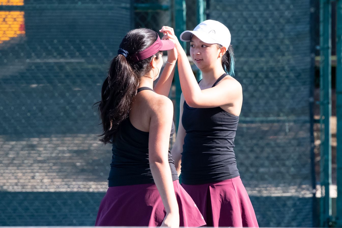 Senior Captains and doubles partners Emma Banaie and Sophie Zeng high-five on the court, a snapshot of the tennis team’s chemistry under their leadership. These two captains were consistently the number one doubles pair in the lineup, leading the team to success with the strong example they set.