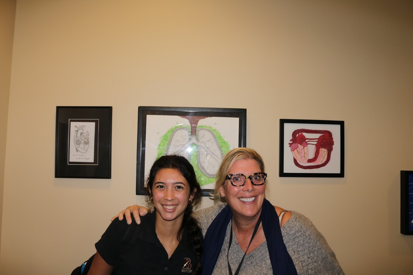 Nora Weise (‘28) and Dean of Students Ms. Michelle Shea smiled beneath a collection of anatomy pieces, including depictions of hearts and lungs, highlighting the artistry behind the showcase.
