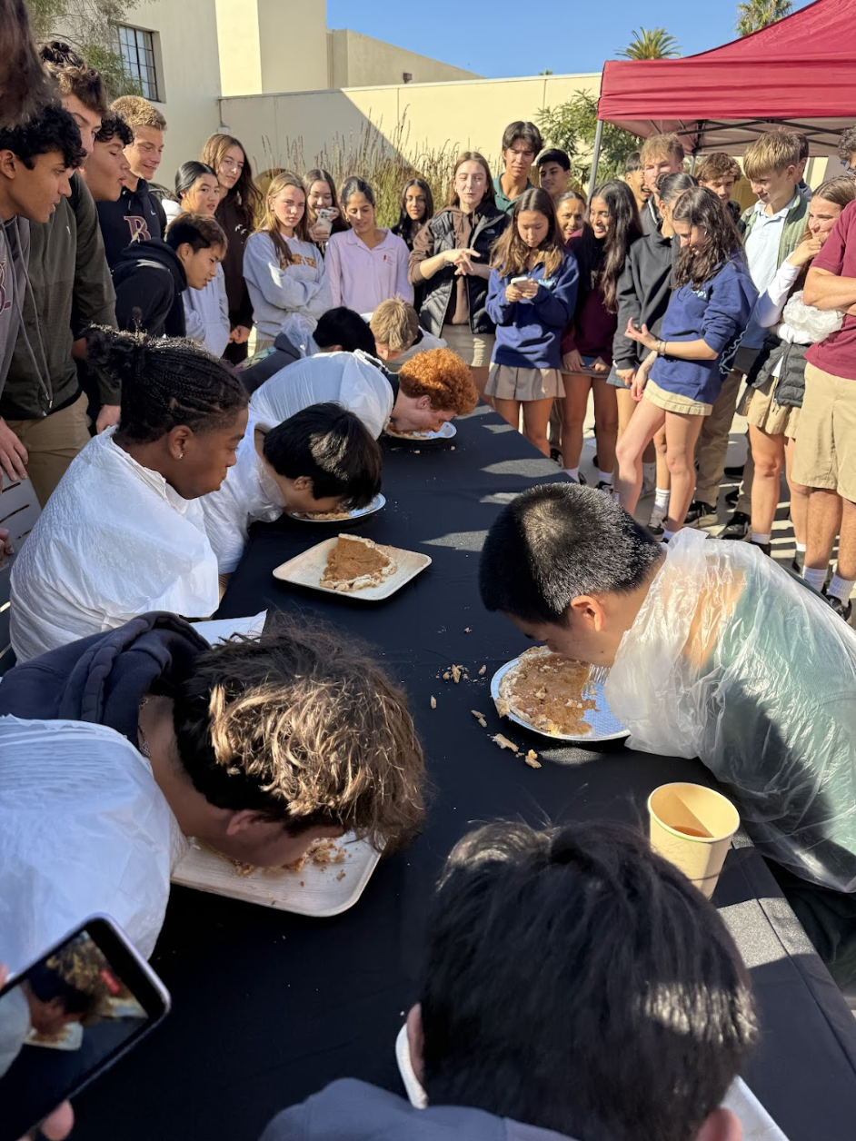 Dig in! Wrapped in trash bags, the contestants were each given half of a pie to devour, and the winner would be crowned the winner, taking home a whole pie for themselves. Spectators cheered them on vigorously — as Naveen Hernandez (‘26) put it, “There’s a lot of eating, and I think that always makes for good sport and good spectacle.” 
