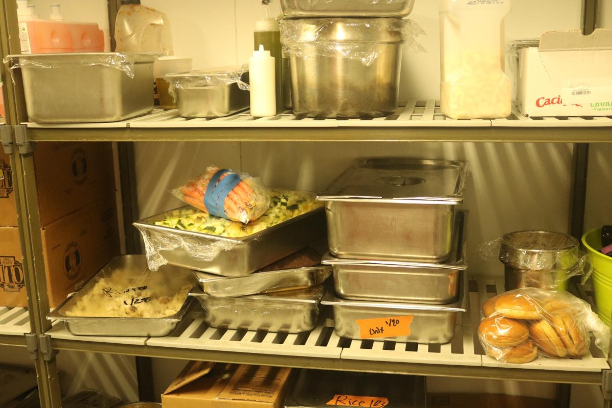 In the back of the kitchen, there are industrial-sized freezers and refrigerators. One refrigerator in particular stores dairy products, leftovers, and stocks for soup, according to Catering Lead Saul Valle.