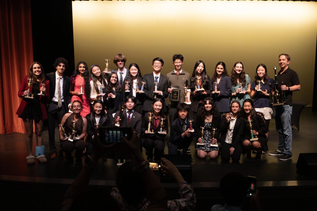 At the end of the award ceremony for the State Qualifying tournaments on March 14, Bishop’s competitors gathered on the stage for a group photo. That included second row from left to right: Sabrina Feldman (‘26), Parsa Avaz-Barandish (‘27), Shreya Sabreesh (‘28), Charlotte Zheng (‘29), Maya Krishnan (‘27), Thomas Kenney (‘26), Fiona Zhang (‘28), Caleb Tang (‘26), Andrew Wang (‘27), Melanie Yau (‘26), Emma Baluja (‘27), Sarah Balfour (‘28), Ivy Yang (‘28), and Speech & Debate Head Coach Mr. Matthew Valji; and first row from left to right: Ariadne Georgiou (‘26), Livia Li (‘28), Tyler Chang (‘26), Ella Xing (‘26), Daniel Guo (‘28), Annika Mody (‘27), Athena Georgiou (‘29), Yina Shate (‘26). 