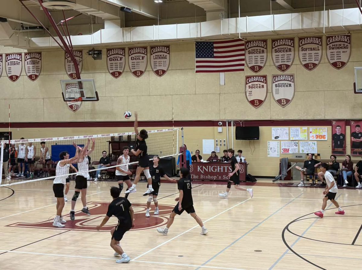 Middle blocker Logan Yockey (‘27) rises above the net for a powerful attack, helping keep the offensive action and further extending the team’s lead. 
